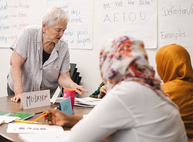 Teacher teaching immigrants english