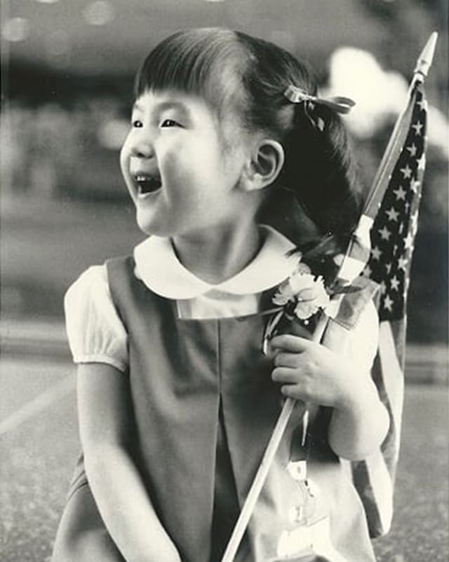 Historical image of little asian girl with American flag